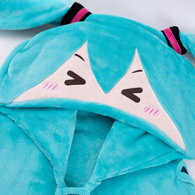 Close-up of Hatsune Miku plush cape hood with cute smiling face and bunny ear design