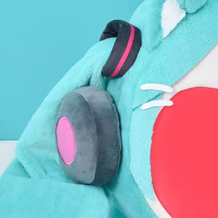 Close-up of plush Miku cat backpack showing grey and pink headphone detail