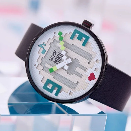 Hatsune Miku pixel-style watch with green twin tails, red heart, and black leather strap.