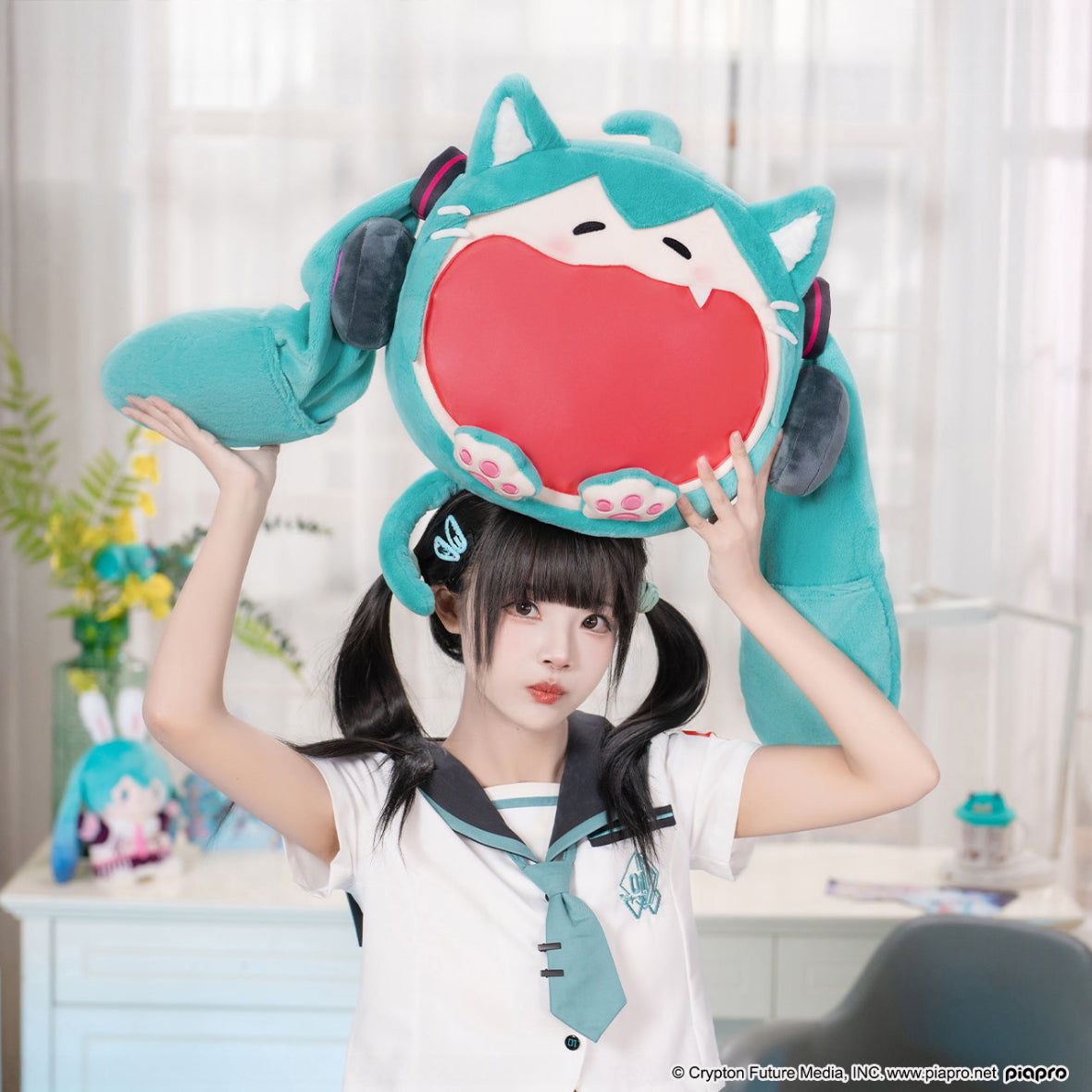 Girl in Hatsune Miku outfit lifting a large Hatsune Miku plush itabag with wide-mouthed design