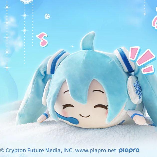 Snow Miku plush in lying pose with headphones and snowflake details, smiling on a snowy background