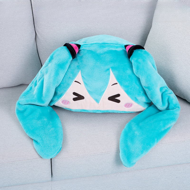 Hatsune Miku plush cape folded into a pillow with bunny ears and cute smiling face design