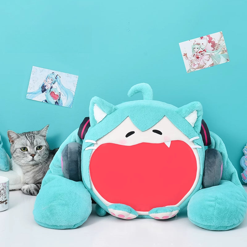 Hatsune Miku plush itabag with wide-mouthed design placed on desk beside cat and Miku wall art