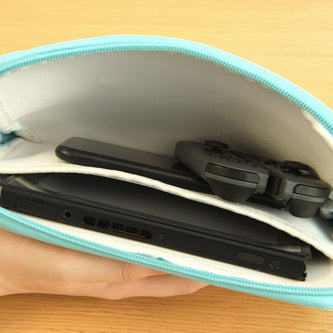 Interior view of storage pouch holding a Switch console, Joy-Con, and a smartphone.