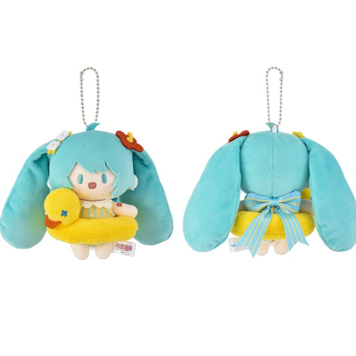 Hatsune Miku plush charm holding a yellow duck with blue hair and a ribbon.