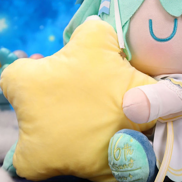 Close-up of Hatsune Miku plush holding a yellow star pillow with “16th” embroidery