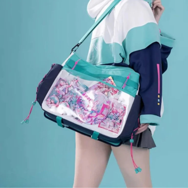 Hatsune Miku itabag with clear front pocket displaying merch, worn over shoulder by model.