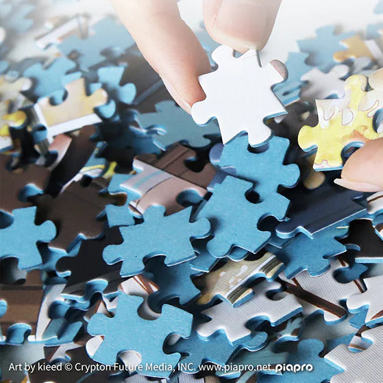 Hands picking colorful Hatsune Miku puzzle pieces from a pile