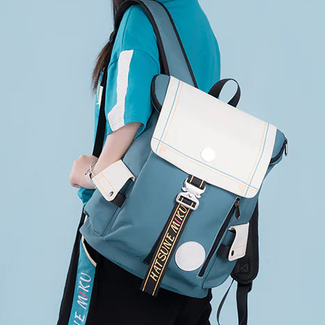 Person wearing a teal and white Hatsune Miku backpack with bold “MIKU” lettering on the strap