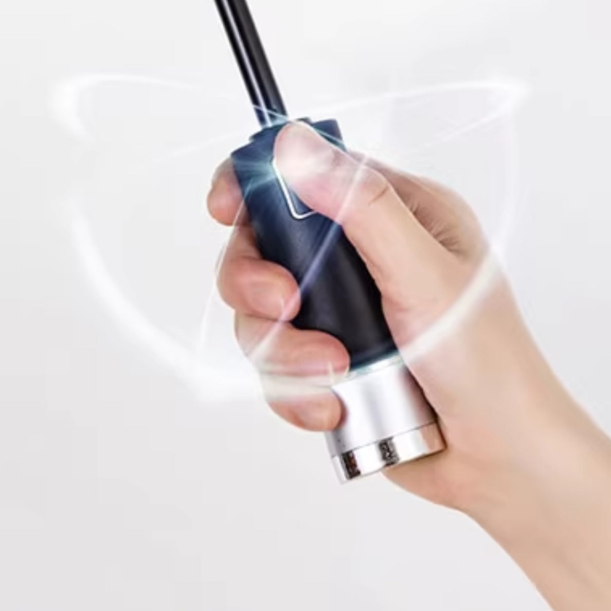 Hand gripping umbrella handle with power button glowing.