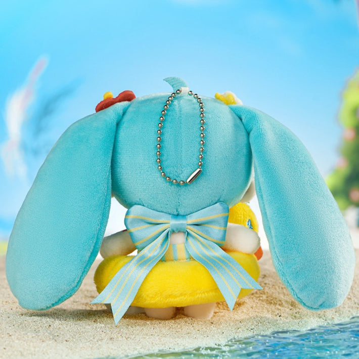 Back view of Hatsune Miku plush charm with a blue ribbon and duck, featuring a keychain.