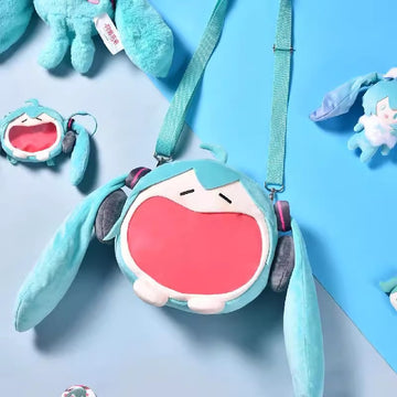 Hatsune Miku open-mouth plush shoulder bag and pouch displayed on blue background.
