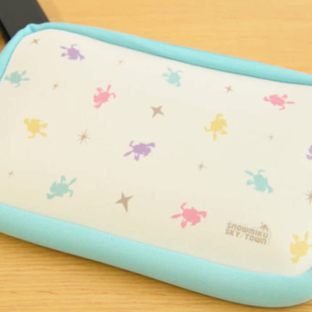 Snow Miku Sky Town soft pouch with colorful Miku silhouettes and blue border.