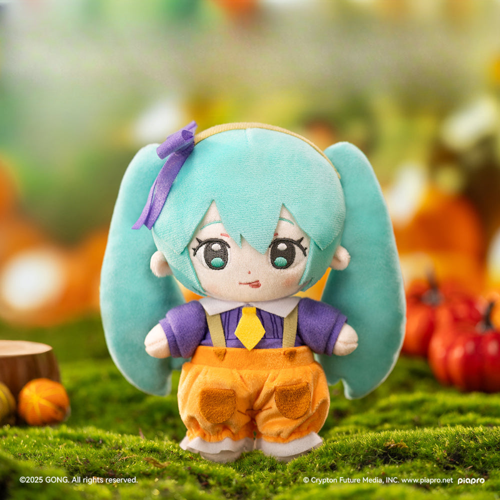 Hatsune Miku Halloween plush doll in pumpkin-themed outfit with purple shirt and orange pants.