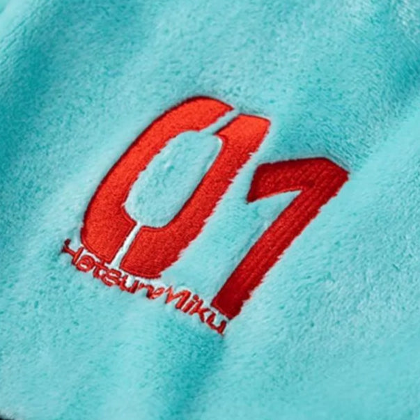 Red "01 Hatsune Miku" embroidery on soft teal plush fabric.