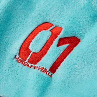 Red "01 Hatsune Miku" embroidery on soft teal plush fabric.